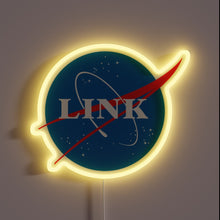 Charger l'image dans la galerie, Neon sign styled like the NASA logo with the word "LINK" in the center, surrounded by stars and a red swoosh, glowing in yellow.