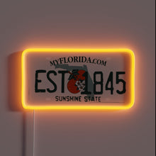 Charger l'image dans la galerie, Neon sign of a Florida license plate with "EST 1845" and orange glow.