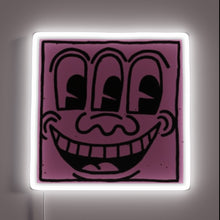Charger l'image dans la galerie, Pop art–style neon sign featuring a quirky purple face with three eyes and a wide grin, outlined by a glowing white neon frame — customneon artwork inspired by Keith Haring
