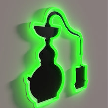 Charger l'image dans la galerie, Moody, vintage-style moonshine still illuminated with colorful RBG neon lights.
