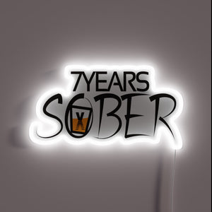 Recovery milestones celebrated with vibrant 7 years sober LED light.