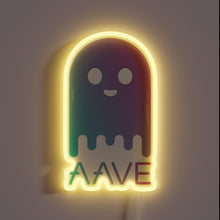 Charger l&#39;image dans la galerie, Alt text: &quot;Neon sign of a smiling ghost figure with gradient colors and the word &#39;AAVE&#39; beneath it, glowing with a yellow outline.&quot;
