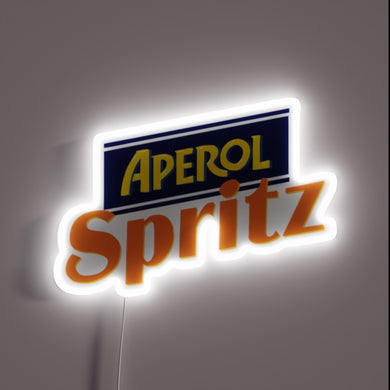 Alt text: *Aperol Spritz neon sign with bold orange and yellow logo glowing on a dark background.*