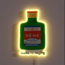 Charger l&#39;image dans la galerie, Neon sign of a green bottle of Chinese Baijiu with red, blue, and white label, glowing yellow, with the text &quot;made in beijing&quot; below.
