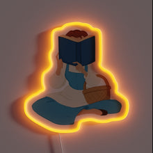 Charger l&#39;image dans la galerie, This neon sign features a cozy silhouette of Belle from *Beauty and the Beast*, sitting with a book and basket, glowing in a soft orange light – a perfect tribute for Disney lovers and bookworms alike.