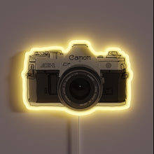 Charger l&#39;image dans la galerie, Iconic Canon AE-1 camera in vibrant neon colors against black background.