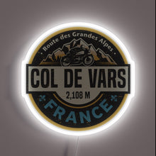 Charger l&#39;image dans la galerie, Neon wall art featuring **Col de Vars** badge with a motorcycle and alpine mountain scene — a rugged tribute to the French Alps for motorbike lovers and adventurers.