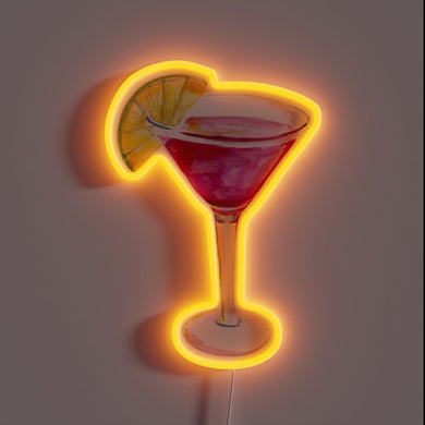 Neon sign in the shape of a red cosmopolitan cocktail glass with an orange slice garnish, glowing with a warm orange outline.
