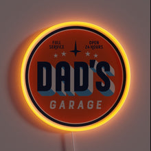 Charger l&#39;image dans la galerie, Retro-style neon sign reading “Dad’s Garage” with “Full Service” and “Open 24 Hours” in small text. The circular sign glows with a warm orange neon border.