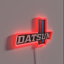 Charger l&#39;image dans la galerie, Vintage Datsun 620 car logo lit up with vibrant RGB neon.