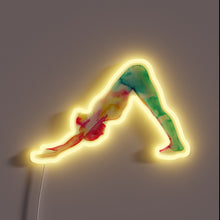 Charger l&#39;image dans la galerie, This neon sign features a silhouette of a person in the &quot;Downward-Facing Dog&quot; yoga pose, rendered in vibrant watercolor-style hues of green, red, yellow, and blue. The glowing yellow neon outline enhances the dynamic and fluid feel of the artwork, making it both calming and energizing—perfect for a yoga studio or wellness space.