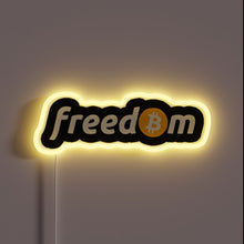 Charger l&#39;image dans la galerie, Alt text: “Neon sign with the word ‘freedom’, where the ‘o’ is replaced by a Bitcoin logo, glowing in yellow.”
