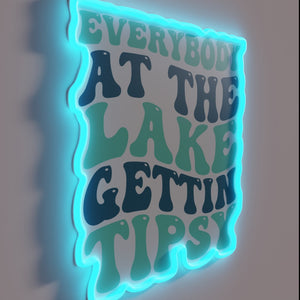 Fun lake vibes with a cheeky 'Gettin' Tipsy' neon sign