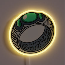 Charger l&#39;image dans la galerie, Alt text: &quot;Neon sign depicting a detailed cartoon-style ring with green gemstones and engraved markings, glowing with a yellow outline.&quot;
