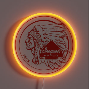 iroquois-beer-customneon-54937 – Vintage-style neon sign featuring the Iroquois Beer and Ale logo with a Native American profile, red detailing, and a bright orange circular glow