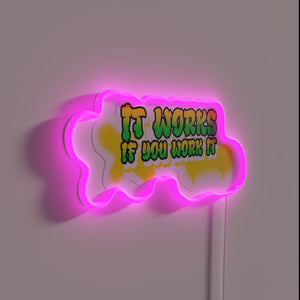 Neon motivational reminder sign with colorful 'work hard' message.