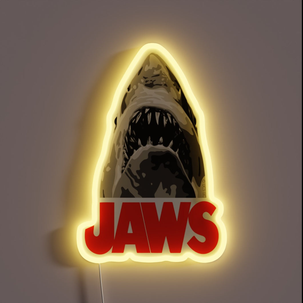 Jaws neon sign with fierce shark and bold red text.