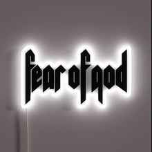 Charger l&#39;image dans la galerie, Alt text: &quot;Neon sign displaying the phrase &#39;fear of god&#39; in bold, gothic-style black lettering, outlined with a glowing white border.&quot;
