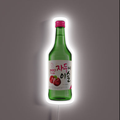 Neon sign of a Jinro Plum soju bottle with Korean text and plum illustration.
