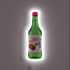 Neon sign of a Jinro Plum soju bottle with Korean text and plum illustration.
