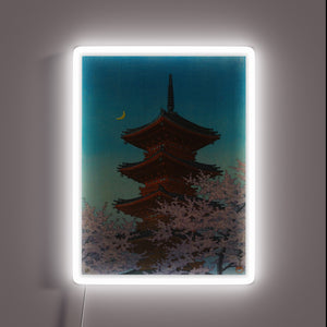 Vibrant neon glow captures tranquil evening scene at Tokyo shrine.