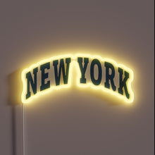 Charger l&#39;image dans la galerie, Neon sign of the words “NEW YORK” in arched bold letters with yellow glow.
