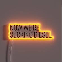 Charger l&#39;image dans la galerie, Neon sign with &#39;Now We&#39;re Sucking Diesel&#39; in bold script.
