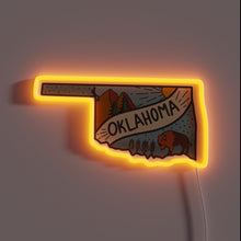 Charger l&#39;image dans la galerie, Oklahoma-shaped neon sign with nature scene, bison, and wheat illustration.