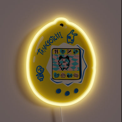 This neon sign captures the nostalgic charm of a classic Tamagotchi, glowing in cheerful yellow with playful pixel art — a perfect tribute to every 90s kid's first digital pet.