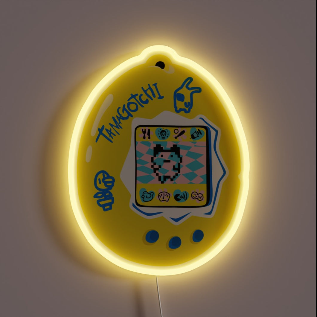 This neon sign captures the nostalgic charm of a classic Tamagotchi, glowing in cheerful yellow with playful pixel art — a perfect tribute to every 90s kid's first digital pet.