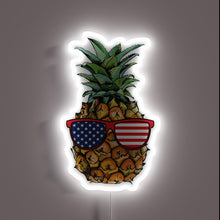 Charger l&#39;image dans la galerie, Neon sign of a pineapple wearing American flag sunglasses.

