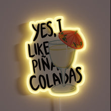 Charger l&#39;image dans la galerie, Neon sign with text “Yes, I like piña coladas” and a cocktail glass with a red umbrella.
