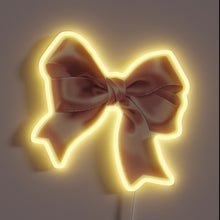 Charger l&#39;image dans la galerie, Vibrant pink bow-shaped LED sign with colorful neon effects.