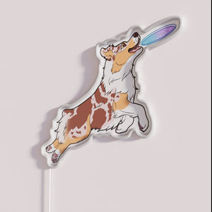Vibrant Neon Sign Depicting Energetic Red Merle Australian Shepherd Playing Fetch.