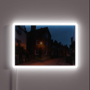 Vibrant evening glow of Robin Hood's Bay in colour-changing neon.