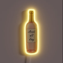 Charger l&#39;image dans la galerie, Neon sign in the shape of a rosé wine bottle with the text &quot;Rosé all day&quot; and a warm yellow glow.
