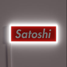 Charger l&#39;image dans la galerie, Alt text: &quot;Red neon sign with the word &#39;Satoshi&#39; in white, glowing with a white border.&quot;

