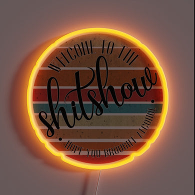 Gaudy, eye-searing neon sign reads 'Shit Show' in bold letters