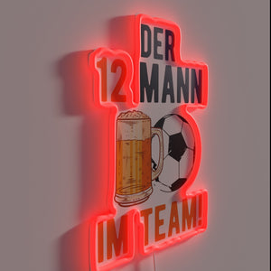 Neon sign featuring soccer player with beer in hand.