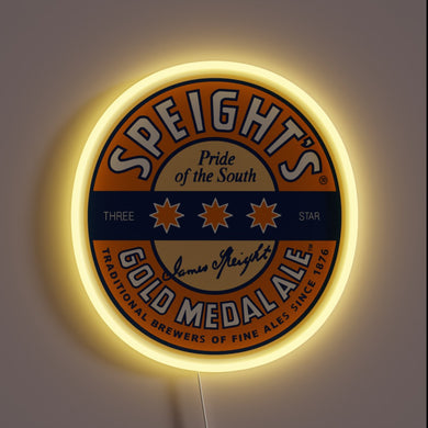 Round neon sign of Speight’s Gold Medal Ale logo with yellow glow.
