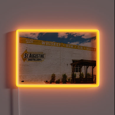 RGB neon sign illuminates historic St. Augustine Distillery at night