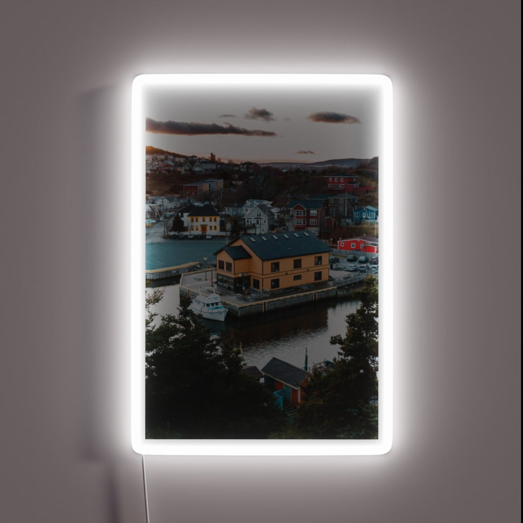 Vibrant sunset backdrop to iconic Quidi Vidi sign, Newfoundland's neon charm