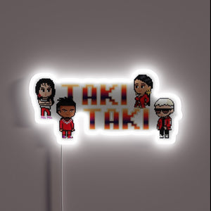 Vibrant Taki Taki logo in colorful RGB neon lighting display.