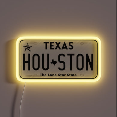 Houston Texas license plate neon sign with yellow glow.