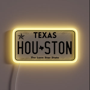 Houston Texas license plate neon sign with yellow glow.