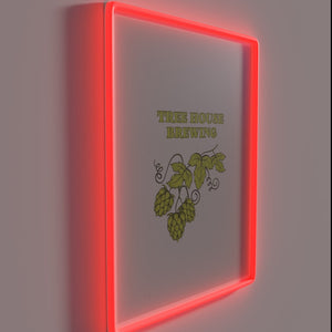 Neon lighted sign featuring a colorful brew house graphic design