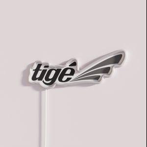 Brightly glowing Tige Boats logo signage in vibrant full color