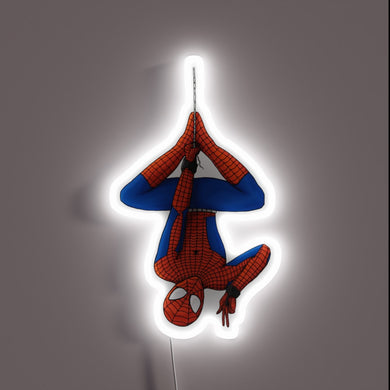 Upside-down Spider-Man neon sign hanging by a web.