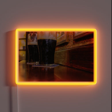 Vibrant RGB lighting illuminates two pints of Guinness in Ireland.