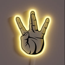 Charger l&#39;image dans la galerie, Alt text: &quot;Neon sign of a hand making the West Coast &#39;W&#39; gesture, outlined with a yellow glow.&quot;
